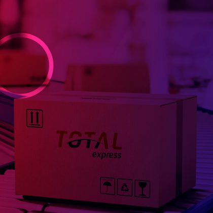 Imagem de uma caixa de papelão com o logotipo da Total Express no que parece ser uma esteira de distribuição